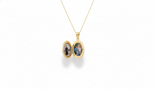 Gold locket necklace with two photo frames on a white background