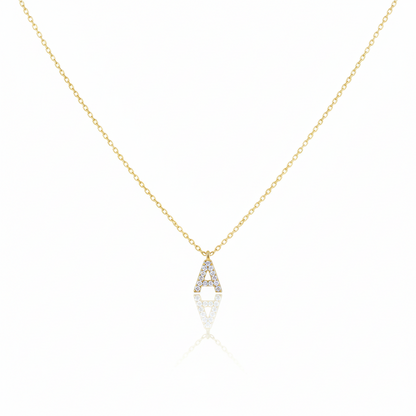 Gold necklace with a diamond pendant on a white background