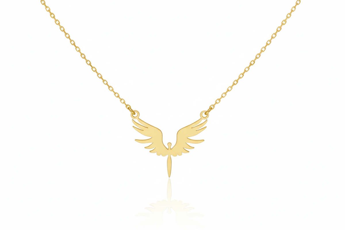 Gold necklace with an angel wing pendant on a white background