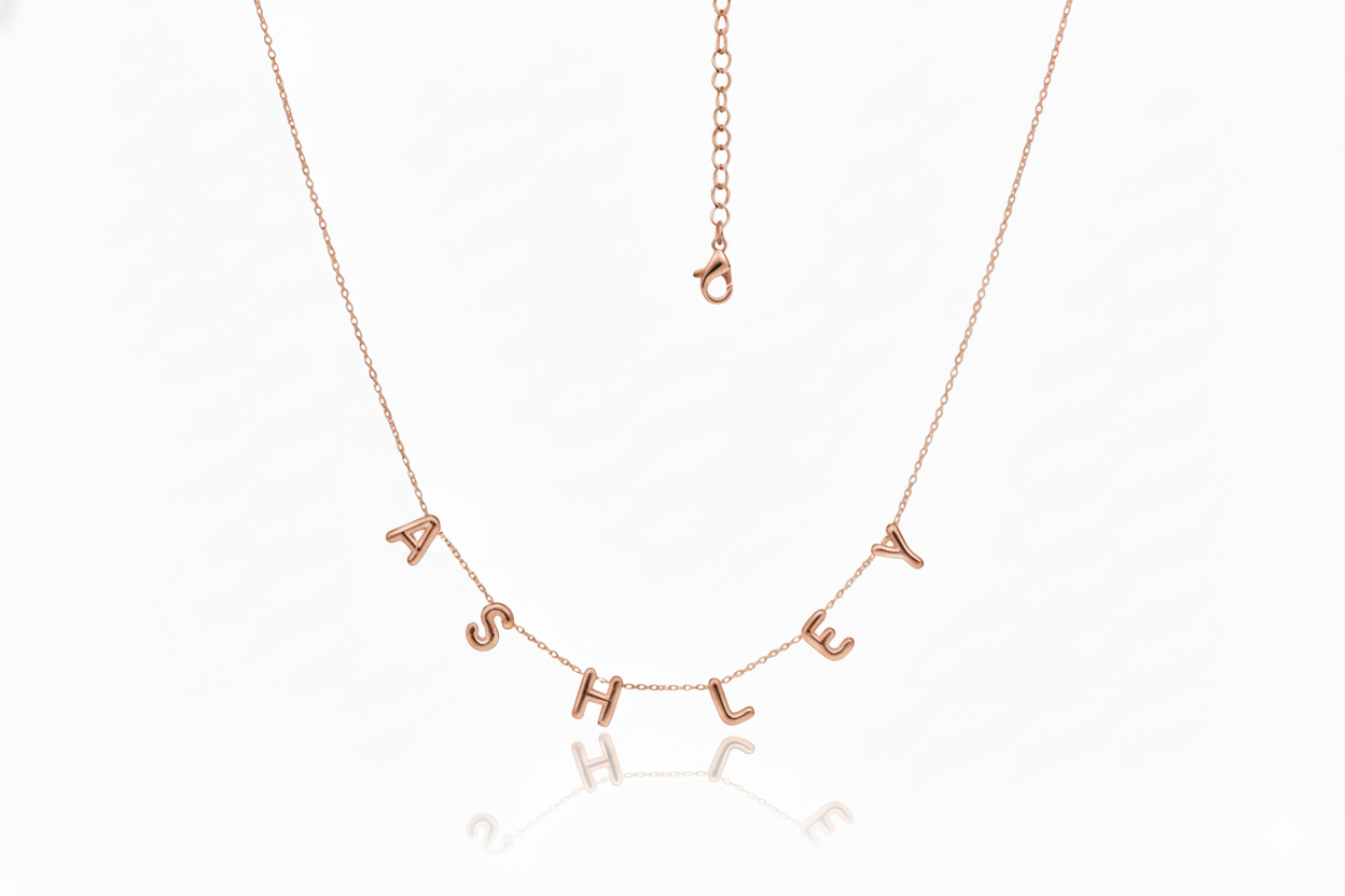 Rose gold necklace with 'ASHLEY' letters on a white background