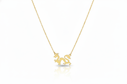 Gold dragon necklace on a white background