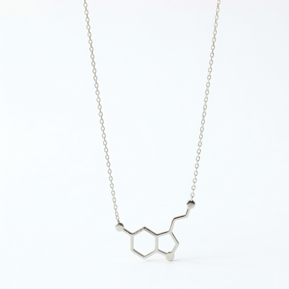 Silver necklace with molecular design on a white background