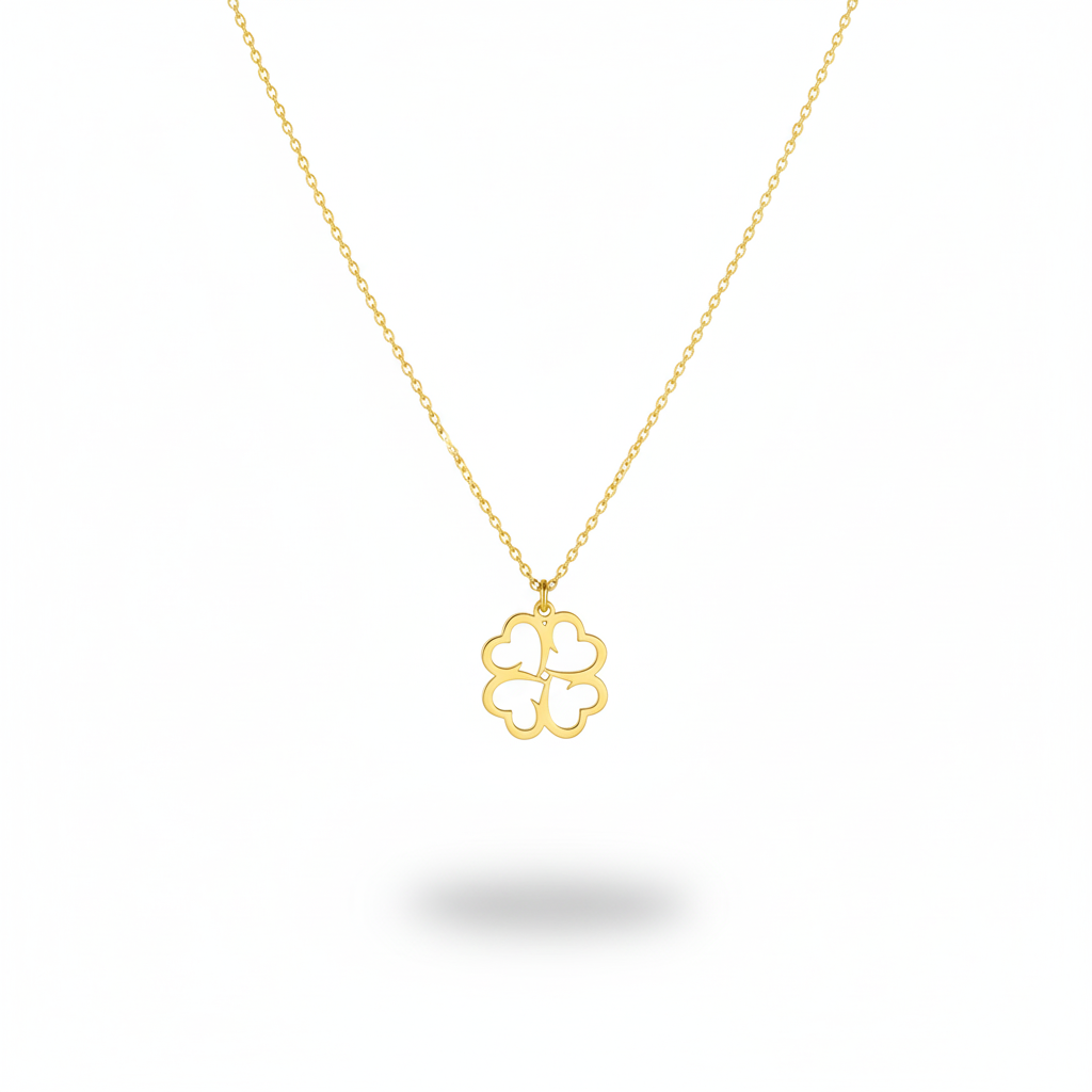 Gold necklace with a clover-shaped pendant on a white background
