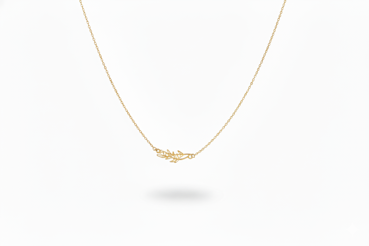 Gold necklace with a delicate leaf pendant on a white background
