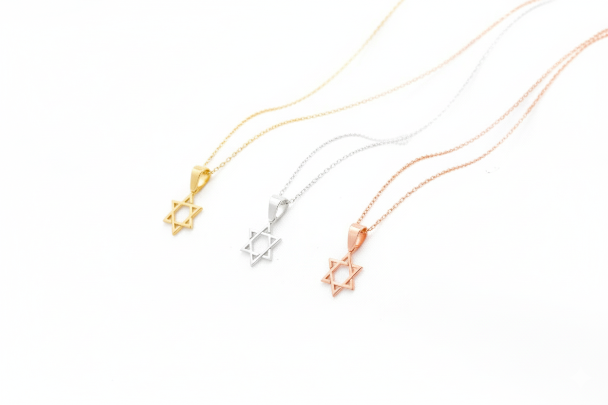 Three necklaces with star-shaped pendants in gold, silver, and rose gold on a white background.