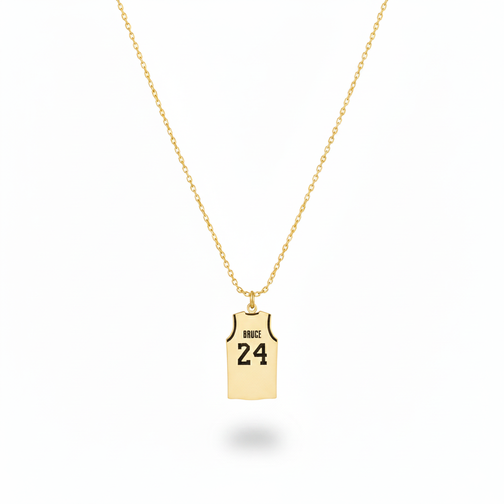 Gold necklace with a pendant shaped like a basketball jersey on a white background