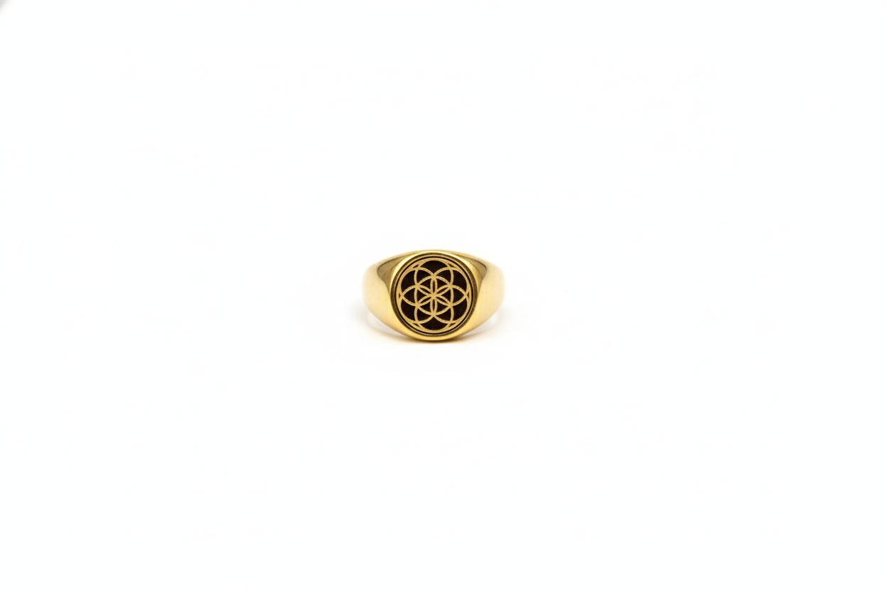 Gold ring with a symbol on a white background