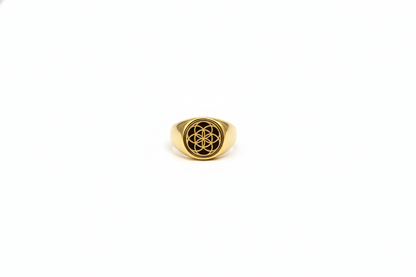 Gold ring with a symbol on a white background