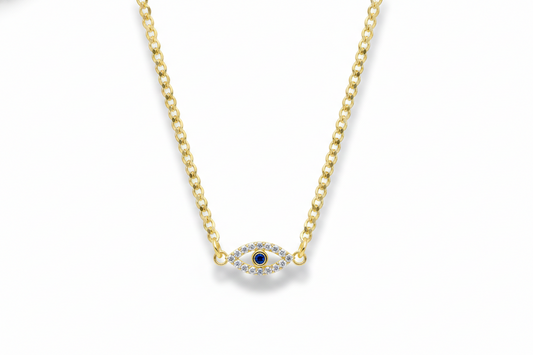 Gold necklace with a small evil eye pendant on a white background
