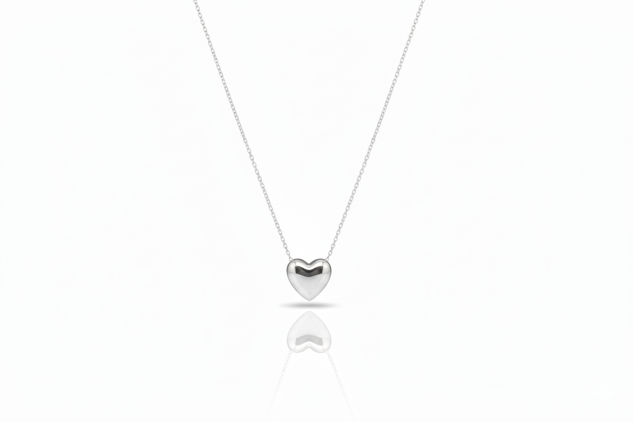 Silver heart-shaped pendant necklace on a white background