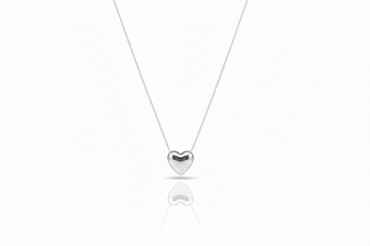 Silver heart-shaped pendant necklace on a white background