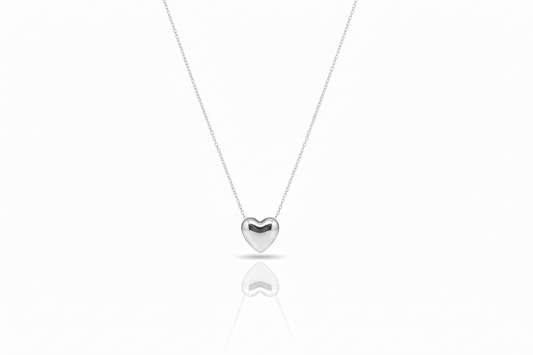 Silver heart-shaped pendant necklace on a white background