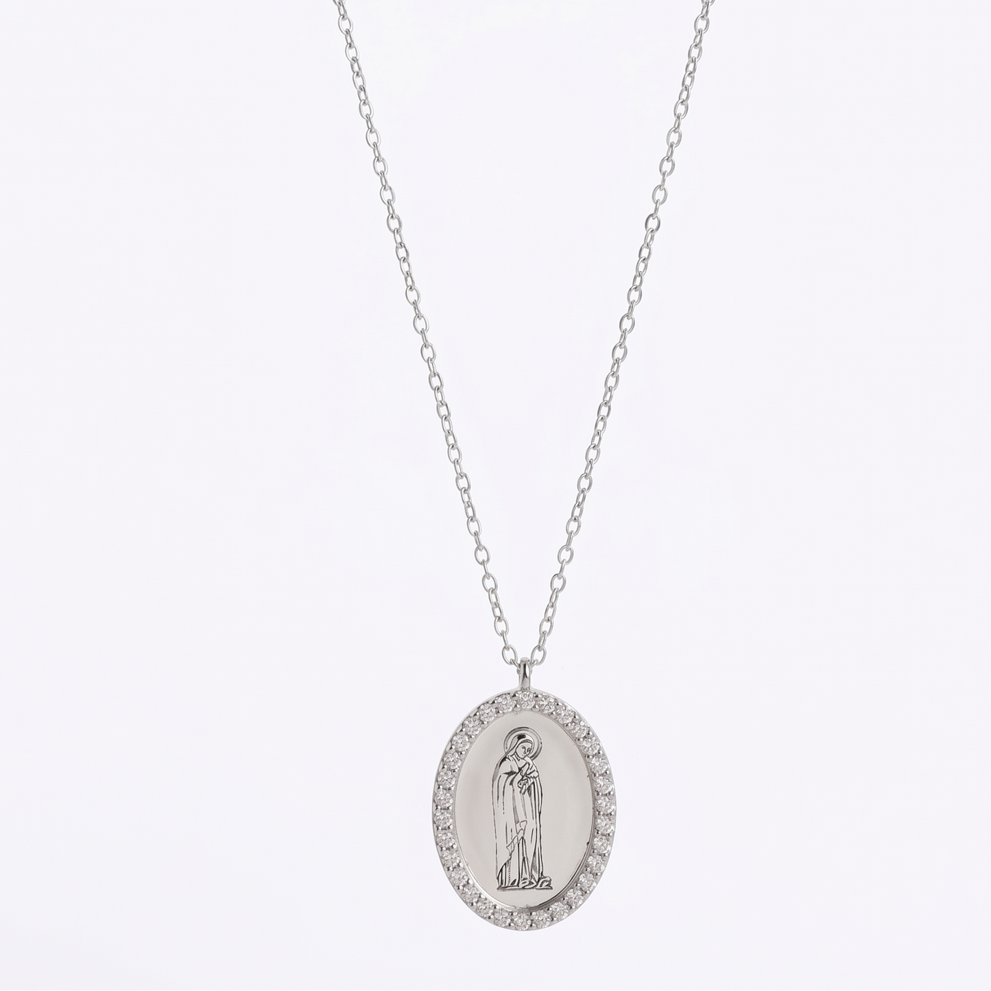 Silver necklace with an oval pendant on a white background