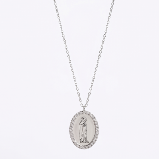 Silver necklace with an oval pendant on a white background