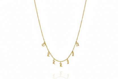 Personalized name necklace with Gothic dangle letters on a gold curb chain, showcasing unique style and elegance.