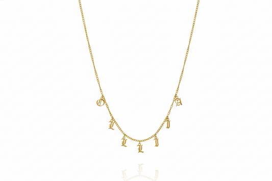 Personalized name necklace with Gothic dangle letters on a gold curb chain, showcasing unique style and elegance.
