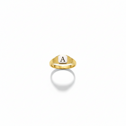 Gold ring with a letter 'A' on a white background