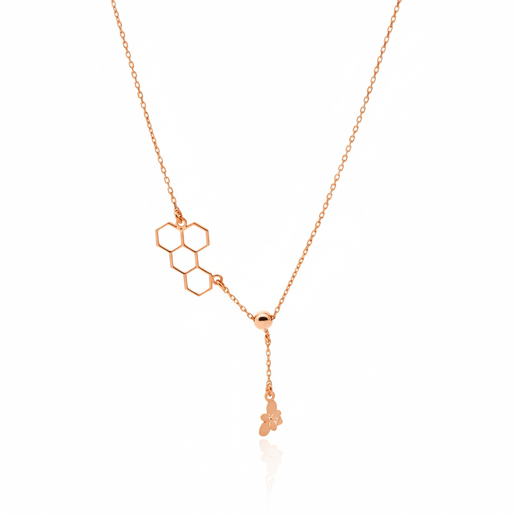 Rose gold necklace with geometric pendant on a white background