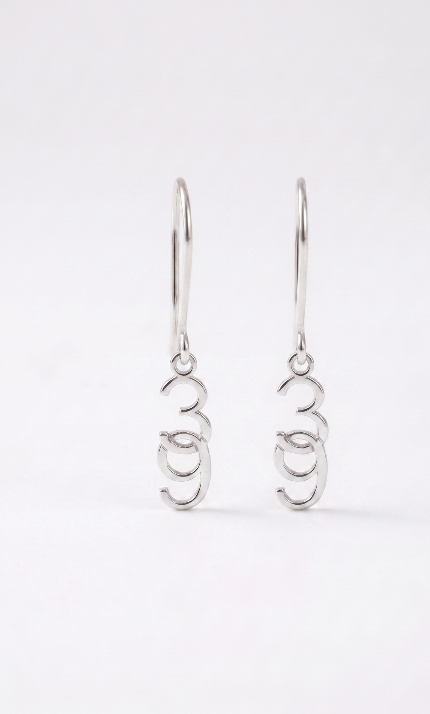 Pair of silver earrings on a white background