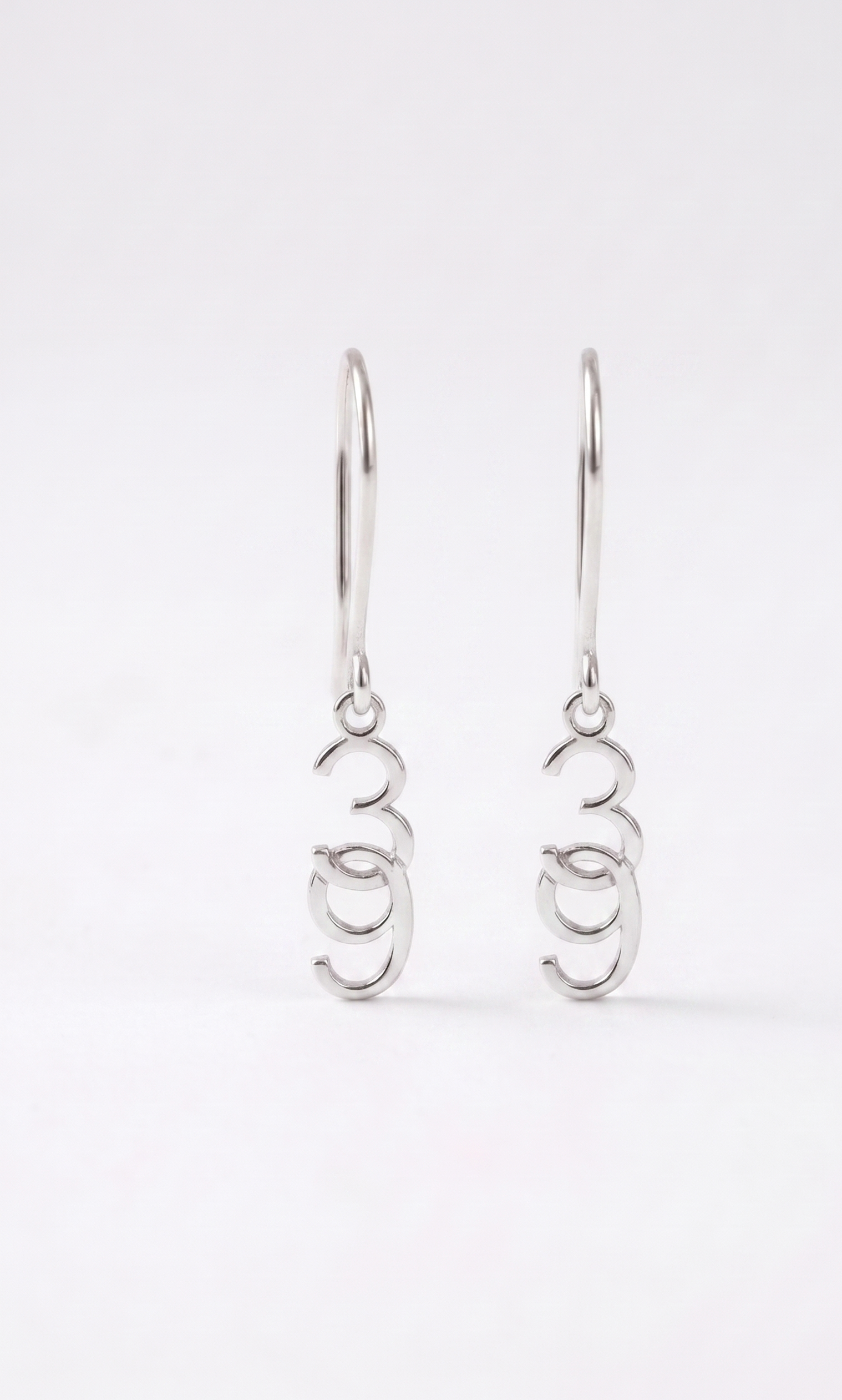 Pair of silver earrings on a white background