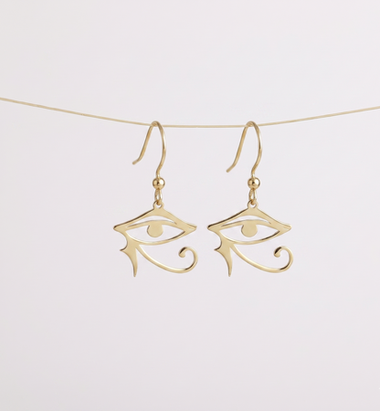 Gold eye-shaped earrings on a white background