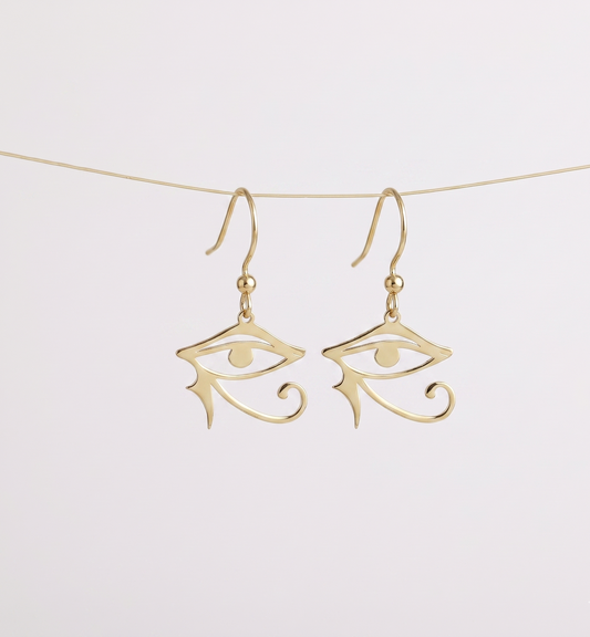 Gold eye-shaped earrings on a white background