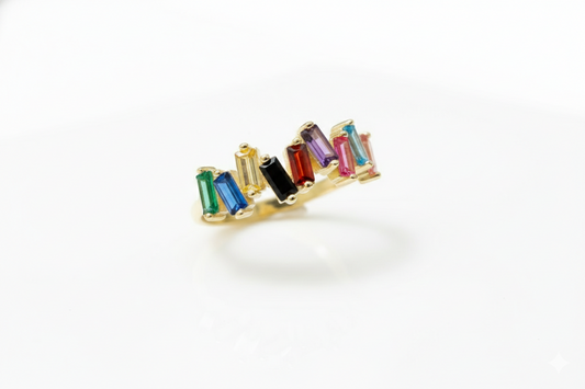 Gold earring with multicolored gemstones on a white background