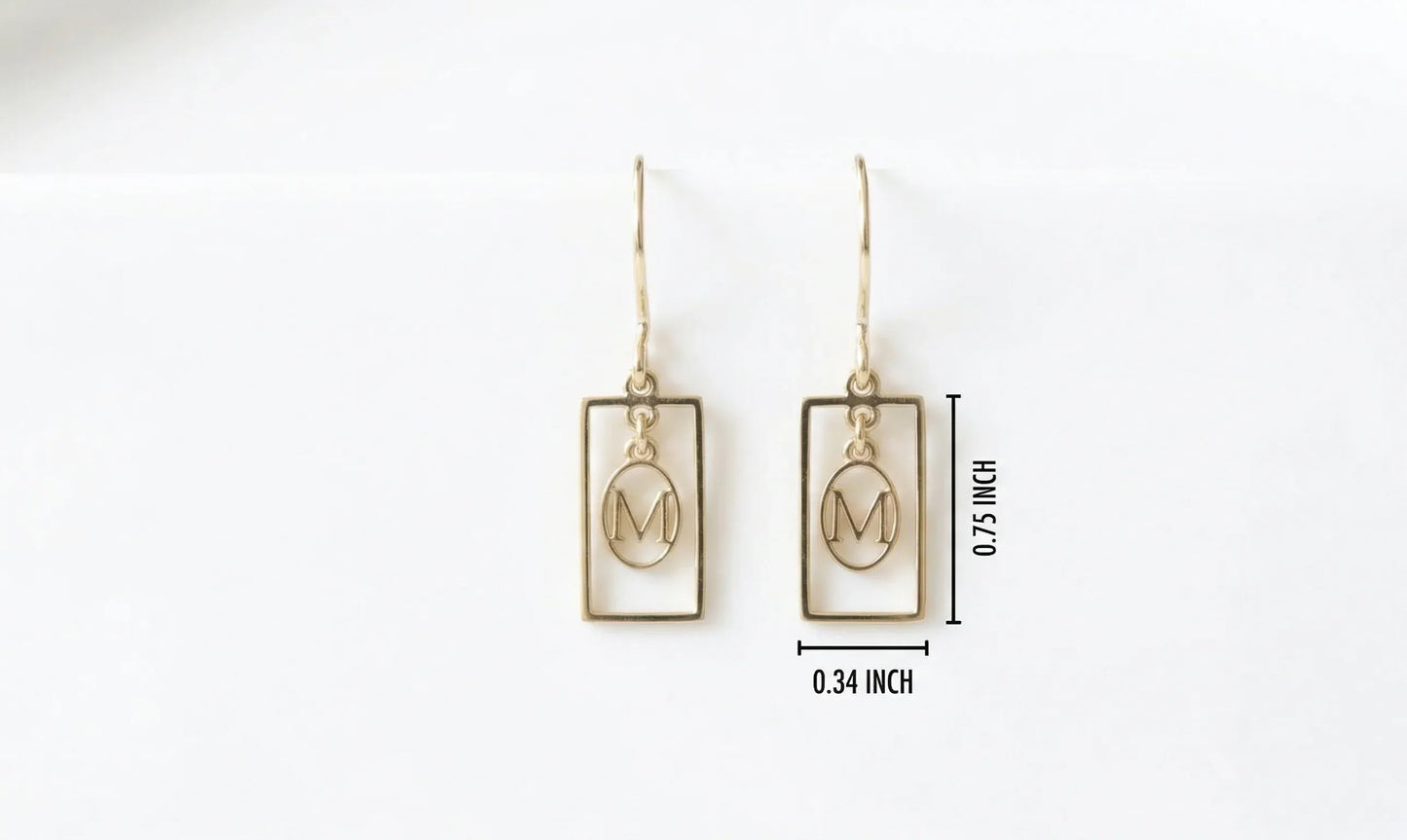 Gold earrings with 'M' design on a white background with measurements.