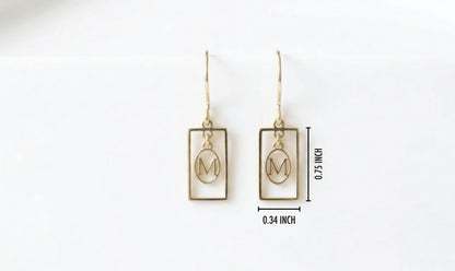 Gold earrings with 'M' design on a white background with measurements.
