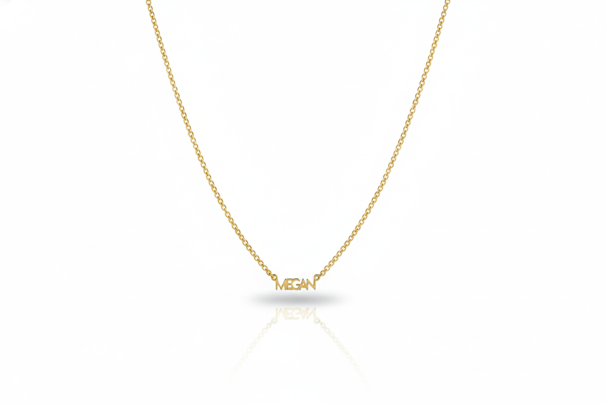 Gold necklace with 'MEGAN' pendant on a white background