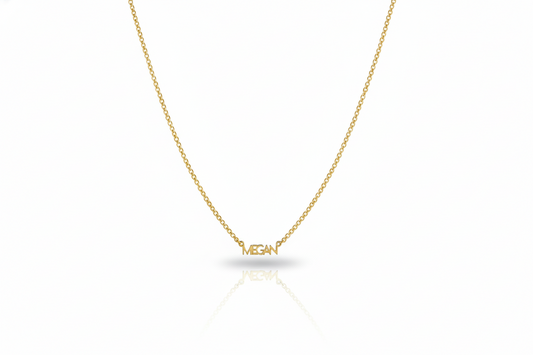 Gold necklace with 'MEGAN' pendant on a white background