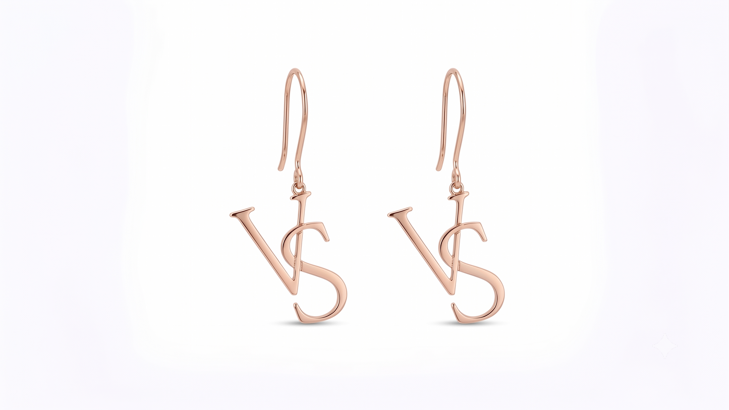 A pair of rose gold drop earrings featuring a stylized interlocking 'VS' monogram design, shown against a plain white background.