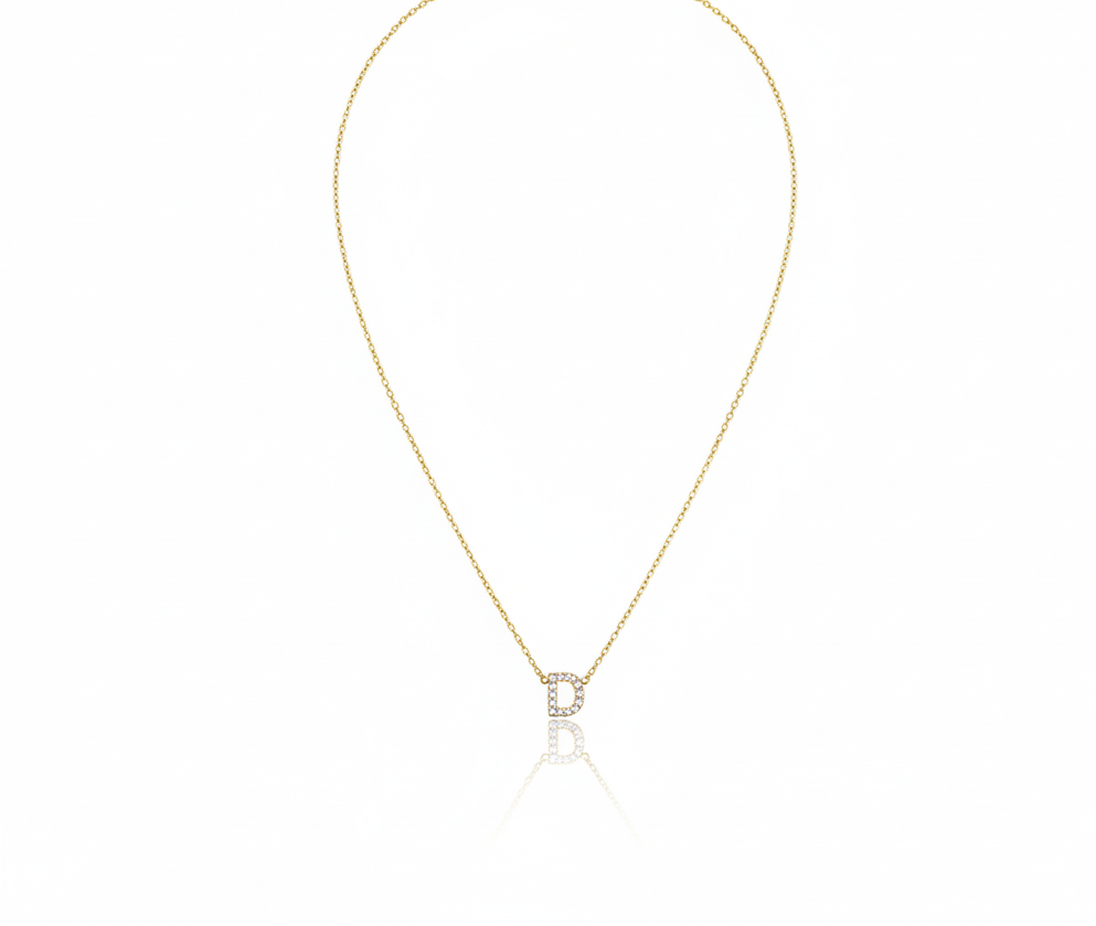 Gold necklace with a small pendant on a white background