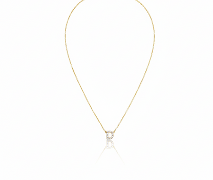 Gold necklace with a small pendant on a white background