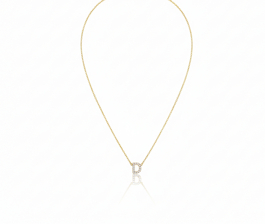 Gold necklace with a small pendant on a white background