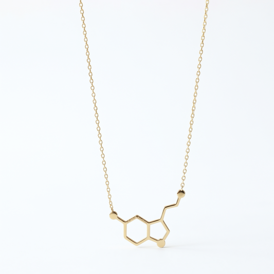 Gold molecular structure necklace on a white background