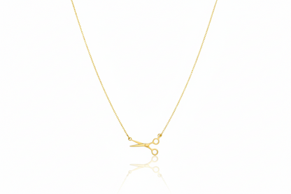 Gold necklace with a small pendant on a white background