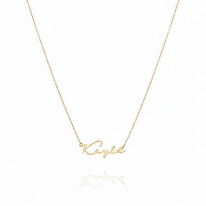 Gold necklace with 'Kayla' pendant on a white background