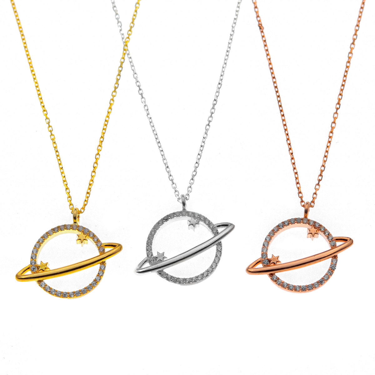 Three planet-shaped necklaces in gold, silver, and rose gold on a white background