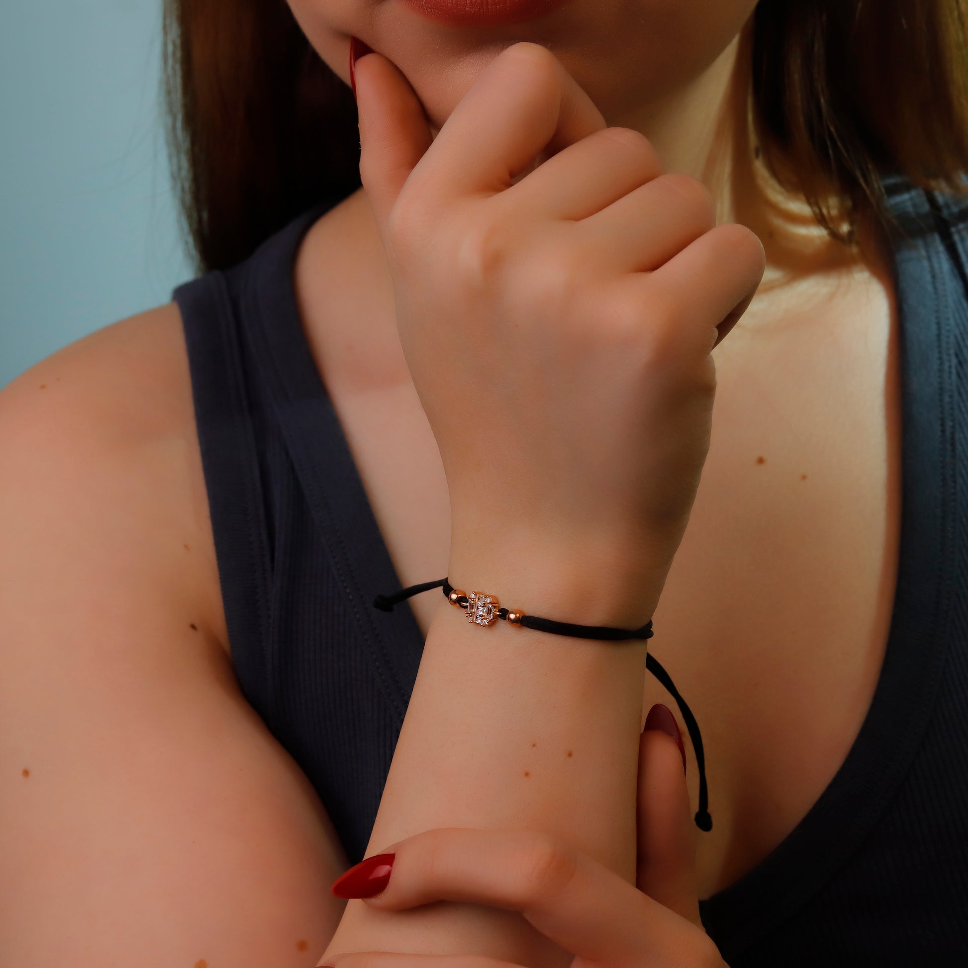 Close-up of a person wearing a bracelet with a small decorative element.