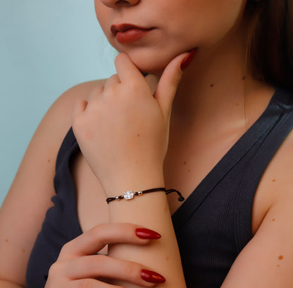 Woman wearing a bracelet with a blue background