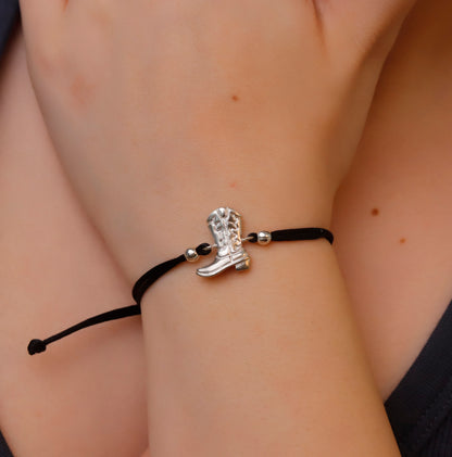 Bracelet with a cowboy boot charm on a wrist