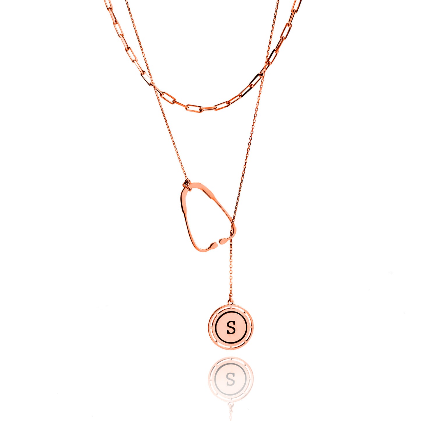 Rose gold necklace with a round pendant featuring the letter 'S' on a white background
