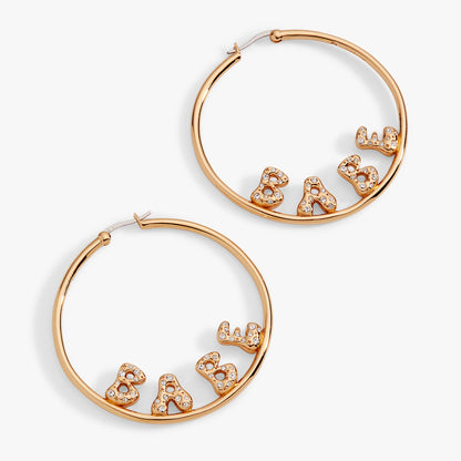 Rose gold hoop earrings with 'Babe' lettering on a white background
