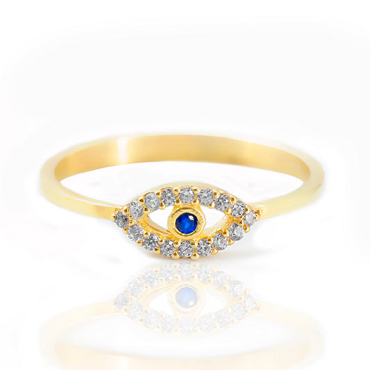 Gold ring with a blue gemstone and clear stones on a white background