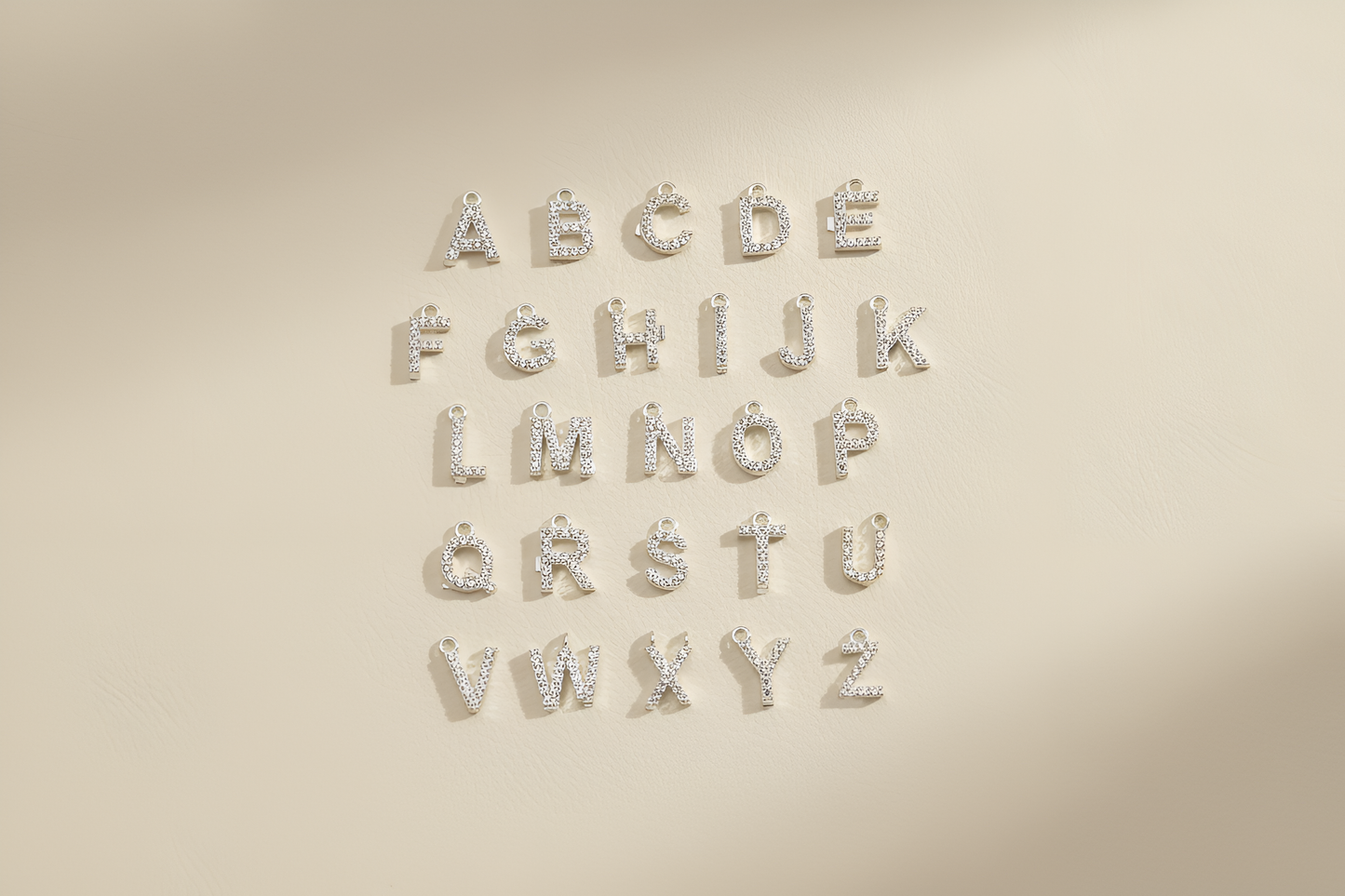 Silver metallic letters on a beige background
