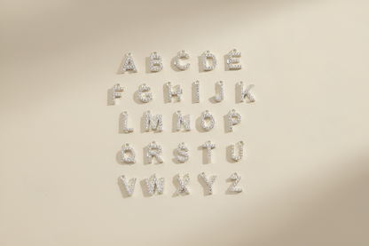 Silver metallic letters on a beige background