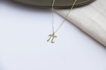  a dainty pendant necklace with the Pi symbol, in a gold-tone finish.