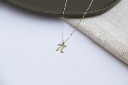 a dainty pendant necklace with the Pi symbol, in a gold-tone finish.