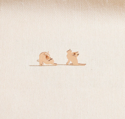 Two small dog figurines on a textured beige surface